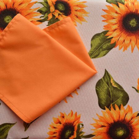 Тишлайфер на слънчогледи в по-светли нюанси съчетан с оранжева платнена салфетка